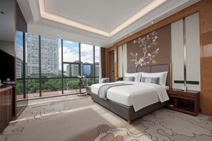 A modern hotel room with a large bed, a view of the city, and a traditional decorative wall.