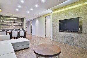 Executive Loft | Living area | 55-inch flat-screen TV with cable channels, TV