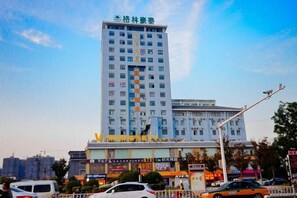 A multi-story hotel with a prominent sign at the top.
