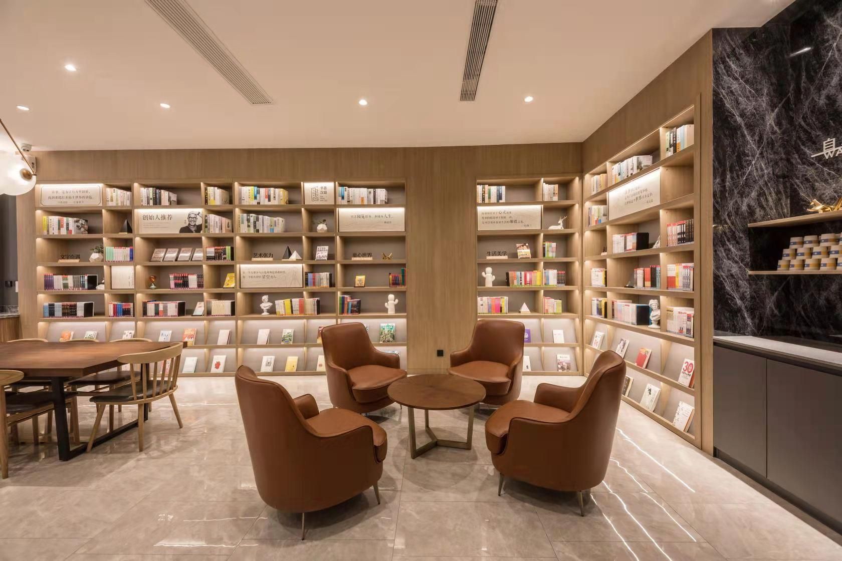 A library with bookshelves, seating, and a marble floor.