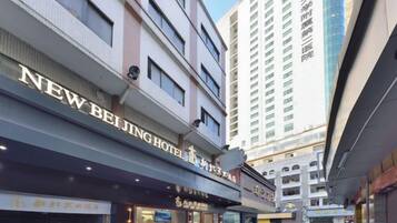 A multi-story hotel with signage for 'NEW BEIJING HOTEL'.