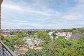 A residential area with a mix of modern and traditional architecture, including a house with a red roof and a white building with a green roof. - 601 at Two six two Florida Road (Durban)