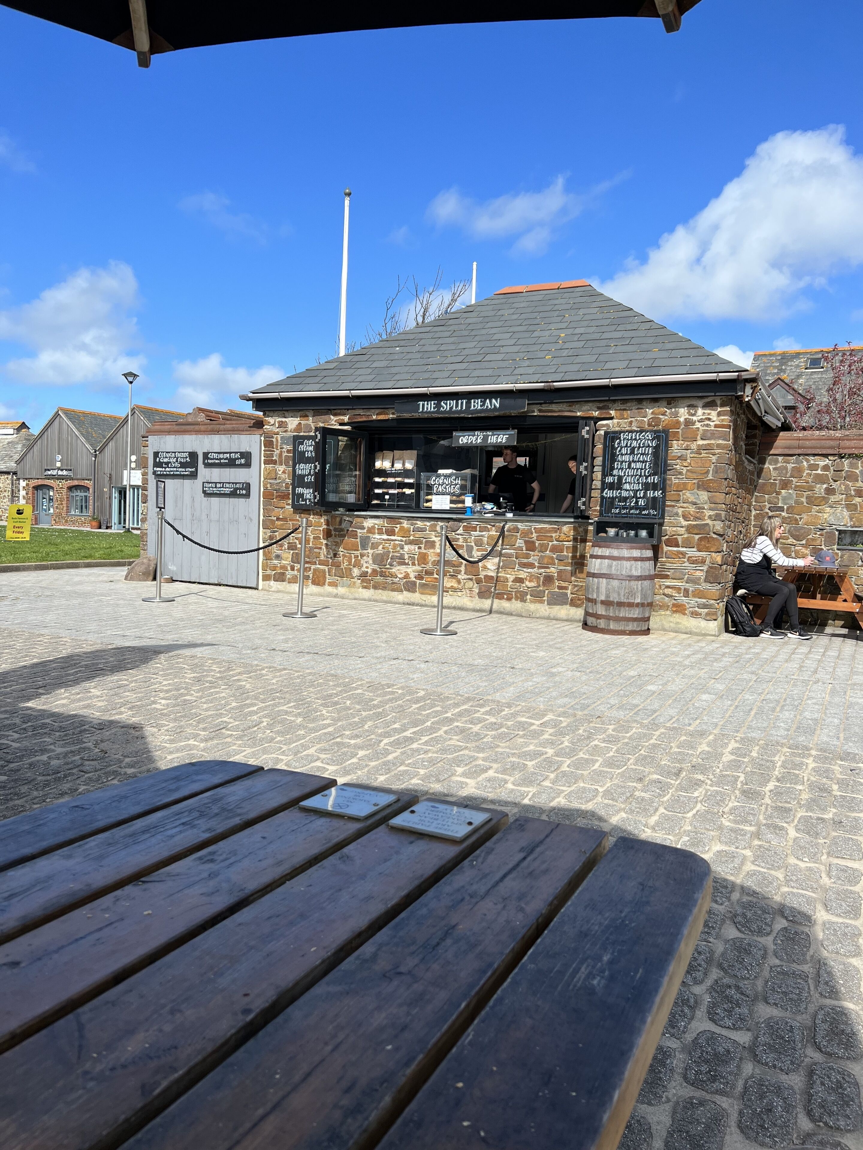 A stone building with a sign reading "The Split Bean" and a menu board.