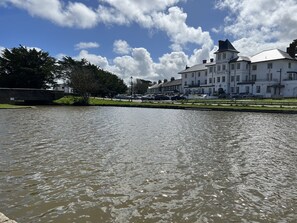 A river with a bridge and a large white building labeled "FALCONY HOTEL" in the background. - Bescot House, Bramble Hill, Bude, 4 bed det House (Bude)