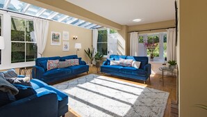 A living room with two blue sofas, a white rug, and a skylight. - Wow, wow! Amazing immaculate period house and hot tub by Bloom Stays - discounts available (Faversham)