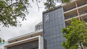 A modern building with a glass facade and a sign reading "2X1X2". - 707 at Two six two Florida Road (Durban)