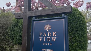 A sign for Park View with a tree logo, stars, and contact information. - Park View (Scarborough)