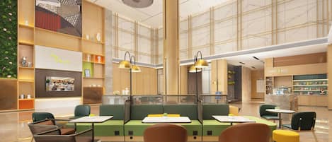 A spacious indoor area with seating arrangements, a large wall with a mural, and a section labeled 'FREE to be you'.