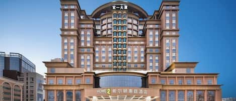 A large, multi-story hotel with a prominent entrance and a curved facade.