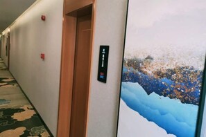 A hotel hallway with a door labeled 'Conference Room 1' and a large wall mural. - Tonghuali Hotel (Lankao)