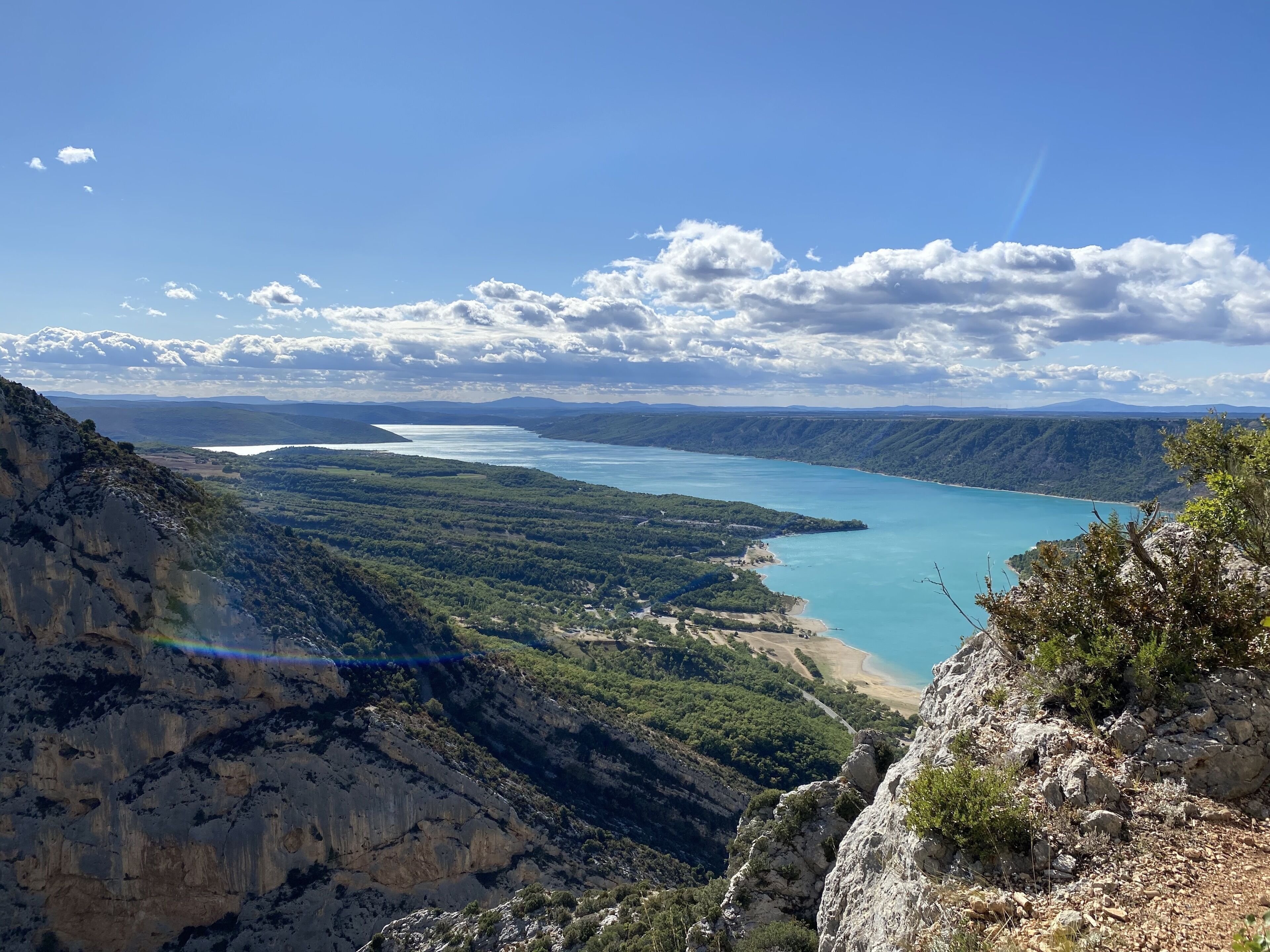 A mountainous landscape with a clear view of a lake and distant mountains.