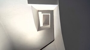 A modern, minimalist interior with a geometric light fixture and clean lines. - The Spiritual Athens Apartment (Athens)