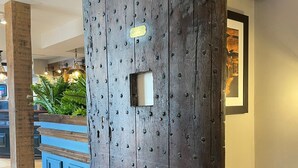 A wooden wall with a built-in light fixture and a framed picture. - Punch House (Monmouth)