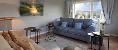 A living room with a sofa, a coffee table, and a lamp.