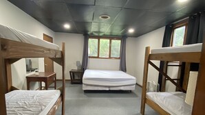A dormitory room with bunk beds, a desk, a chair, a window with curtains, and a ceiling light. - Outlaw Lodge (McCoy Floor 2nd)ATV,SXS, MX Offroad lodging (Iaeger)