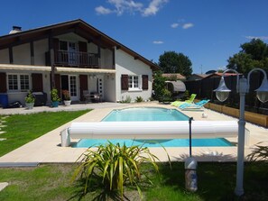 A two-story house with a swimming pool, outdoor furniture, and a well-maintained lawn. - Cozy country home, ideal for a couple with two or three children (Azur)