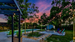 A backyard with a swimming pool, outdoor seating, and a pergola. - SWEET HOME With Private Pool, Patio,& Huge backyard. (Orange Park)