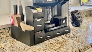 A coffee machine with a water reservoir, a coffee pod holder, and a mug rack on a kitchen counter. - Bethany’s - Charming 4-bedroom Historic Home in Downtown Jackson (Jackson)