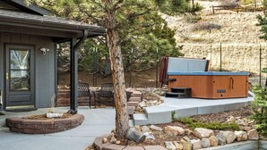 A house with a covered porch, a hot tub, and a stone pathway leading to the entrance.