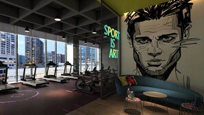 A modern gym with treadmills, exercise bikes, and a large wall mural with the text "SPORT IS ART". - Aloft Shijiazhuang (Shijiazhuang)