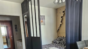Une chambre à coucher moderne avec un lit, un canapé, un bureau et un escalier.