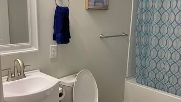 Combined shower/bathtub, towels, soap, toilet paper