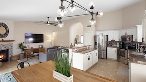 A modern kitchen with white cabinets, stainless steel appliances, and a central island. - On HGTV Show House Hunters! Heated Pool! Family & Dog friendly, Prime location!  (Gilbert)