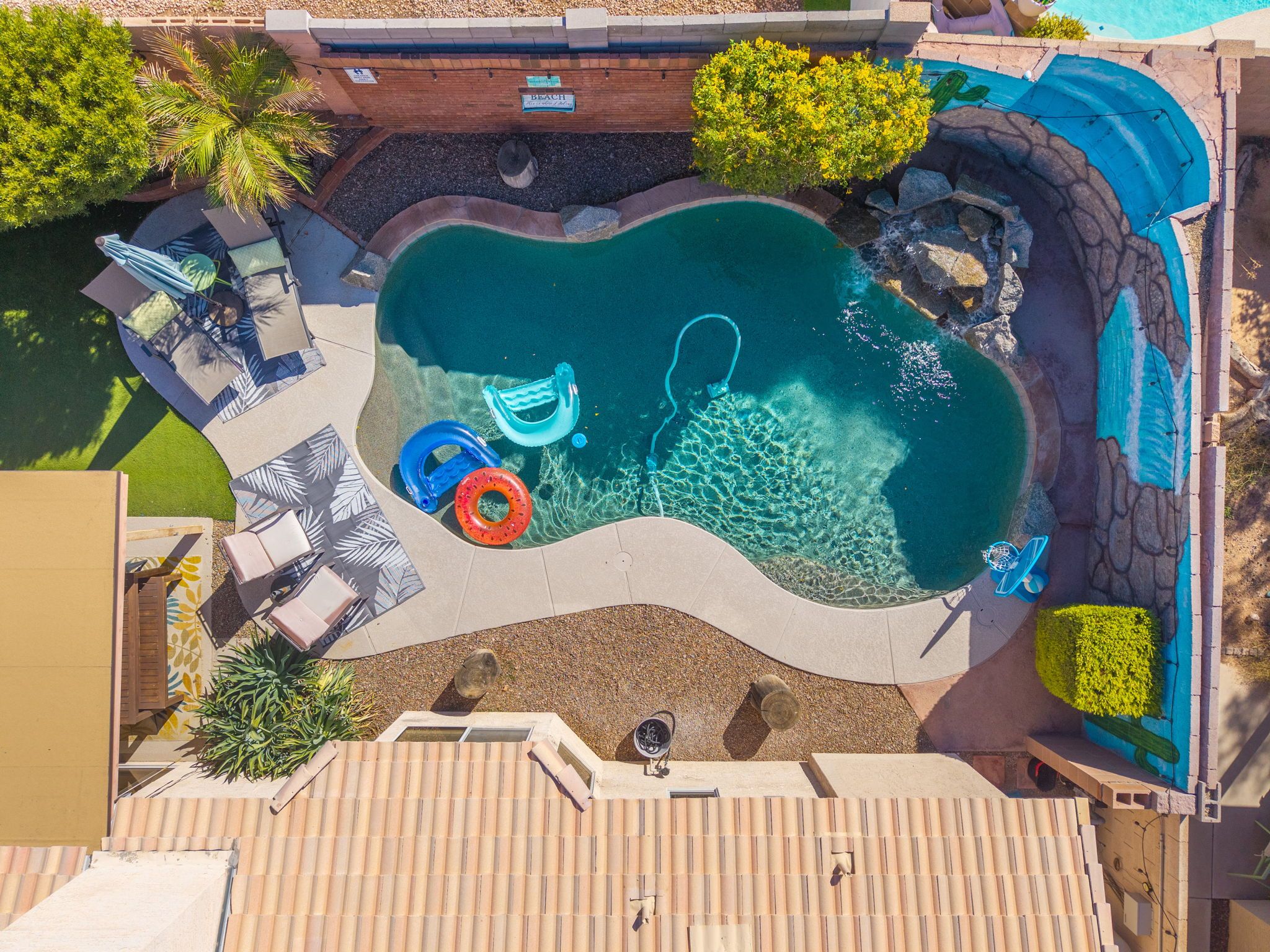 Entertainment backyard complete with heated pool and relaxing waterfall.