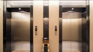 A modern elevator with metallic doors and a central control panel. - Kyriad Hotel (Zijin Wanhui Branch) (Zijin)