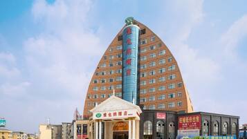 A hotel with a distinctive triangular roof and a large entrance.