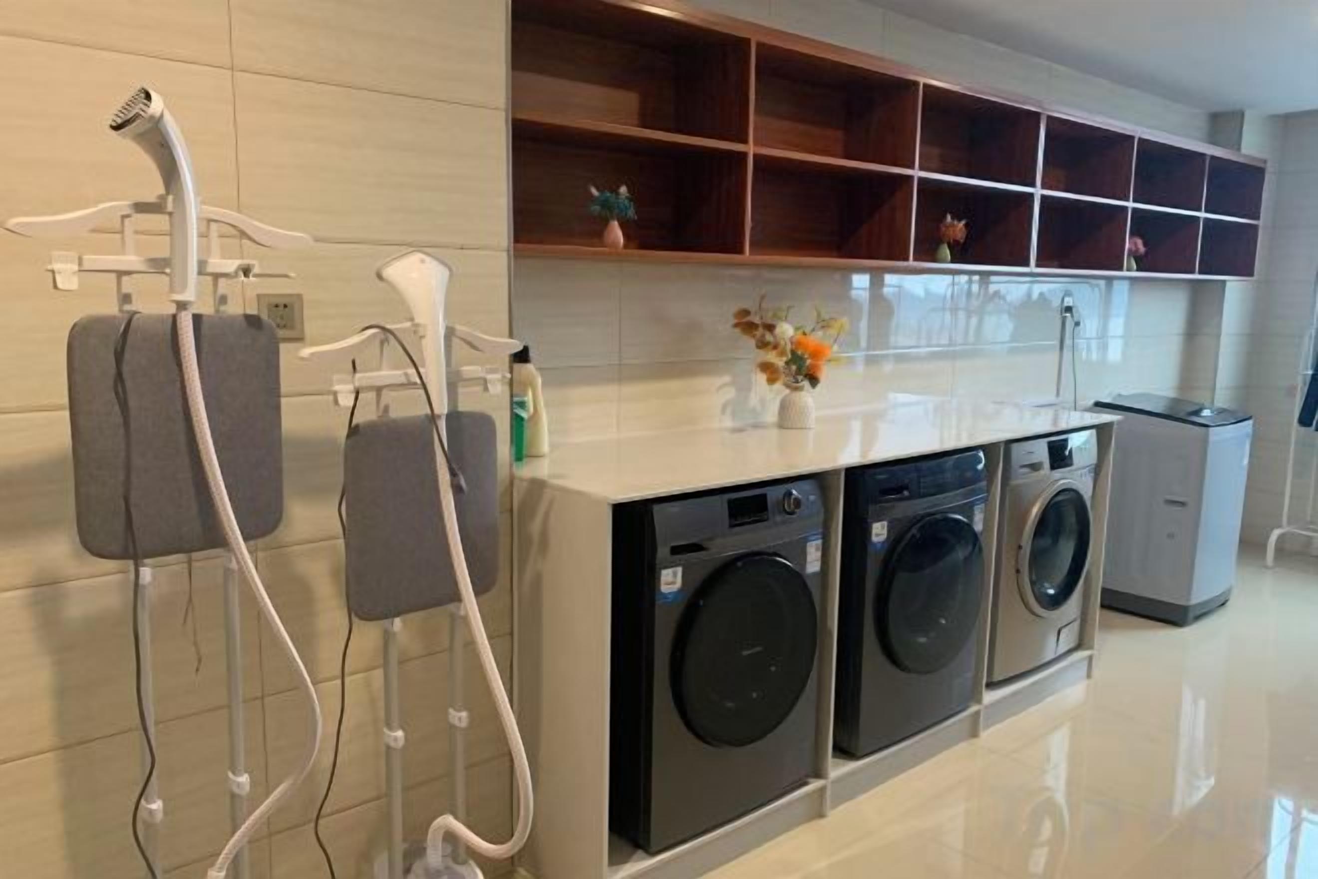 A laundry area with a washing machine, dryer, and a hairdryer.