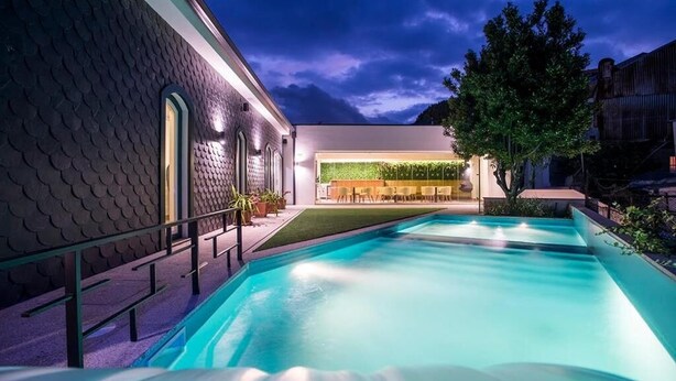 A swimming pool with a modern building in the background.