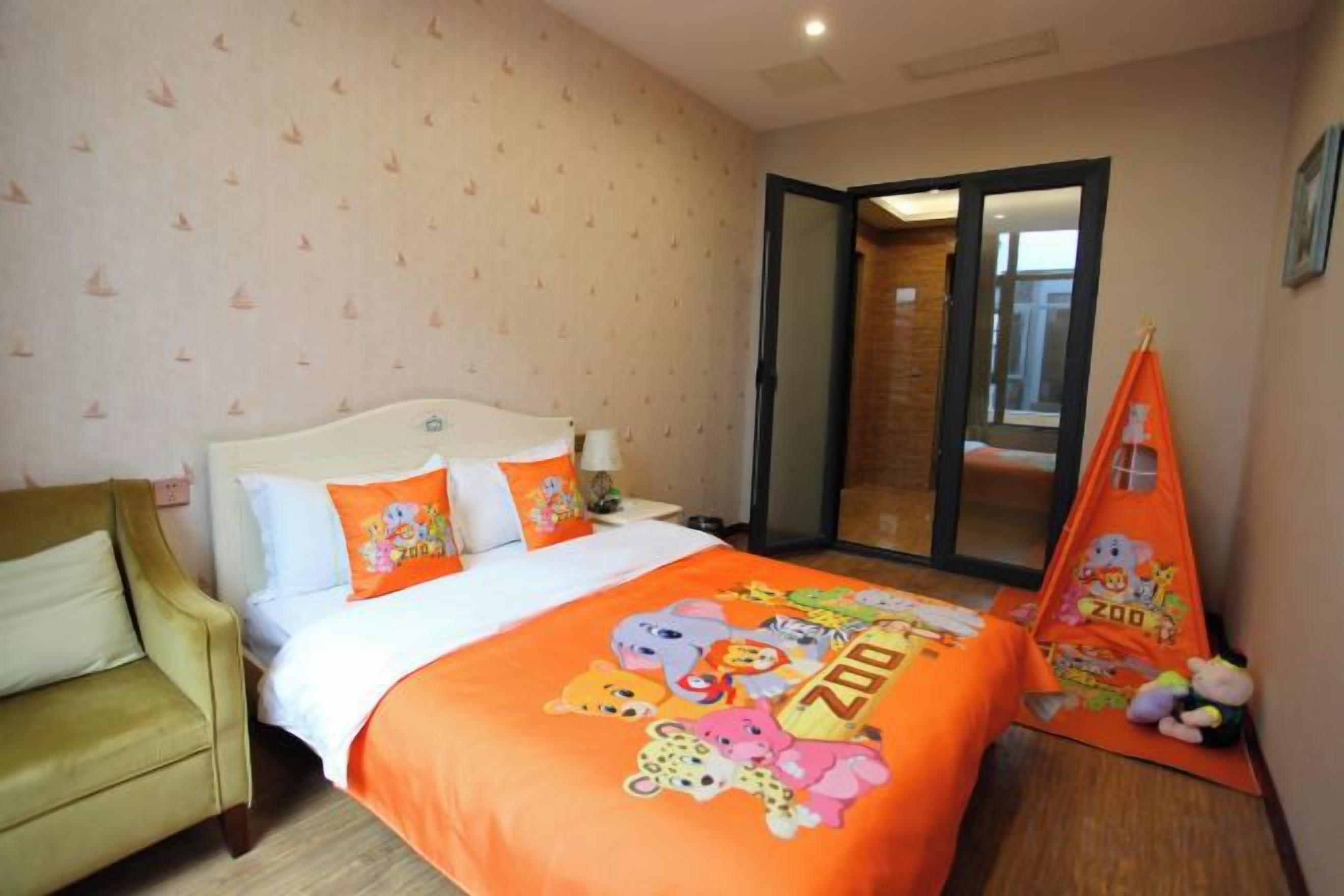 A bedroom with a bed, a chair, a window, and a door.