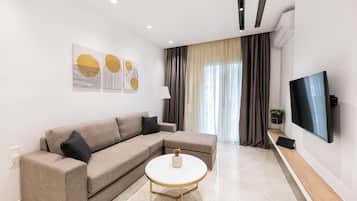 Deluxe Apartment | Living area | 45-inch Smart TV with digital channels, tablet