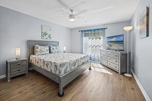 A bedroom with a bed, nightstands, a dresser, a ceiling fan, and artwork on the walls. - ☆☀︎❀ Tropical Paradise! Heated Pool, Boat Parking, Near Beaches! (Sebastian)
