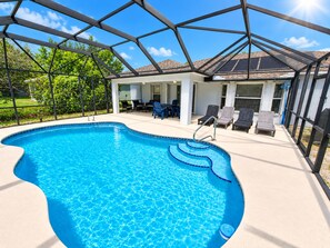 An indoor swimming pool with a clear view of the surrounding area, including a covered patio with lounge chairs and a table. - ☆☀︎❀ Tropical Paradise! Heated Pool, Boat Parking, Near Beaches! (Sebastian)