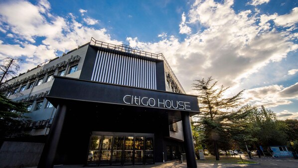 A modern building with a sign reading 'CITIGO HOUSE' and a glass entrance.