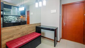 A modern kitchen with a wooden bench and a black table.