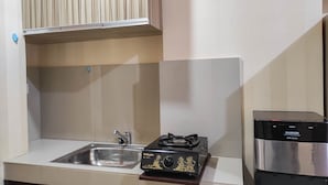 A kitchen with a sink, a stove, and a water dispenser.
