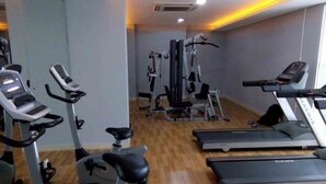 A gym with treadmills, elliptical machines, and weight machines. - Simple and Cozy Living Studio Room at Bassura City Apartment (Jakarta)