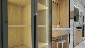 A modern kitchen with wooden cabinets and a marble countertop. - Comfortable and Simply 1BR at The Boulevard Apartment (Jakarta)