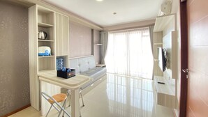 A modern kitchen with a built-in island, a seating area, and a large window.