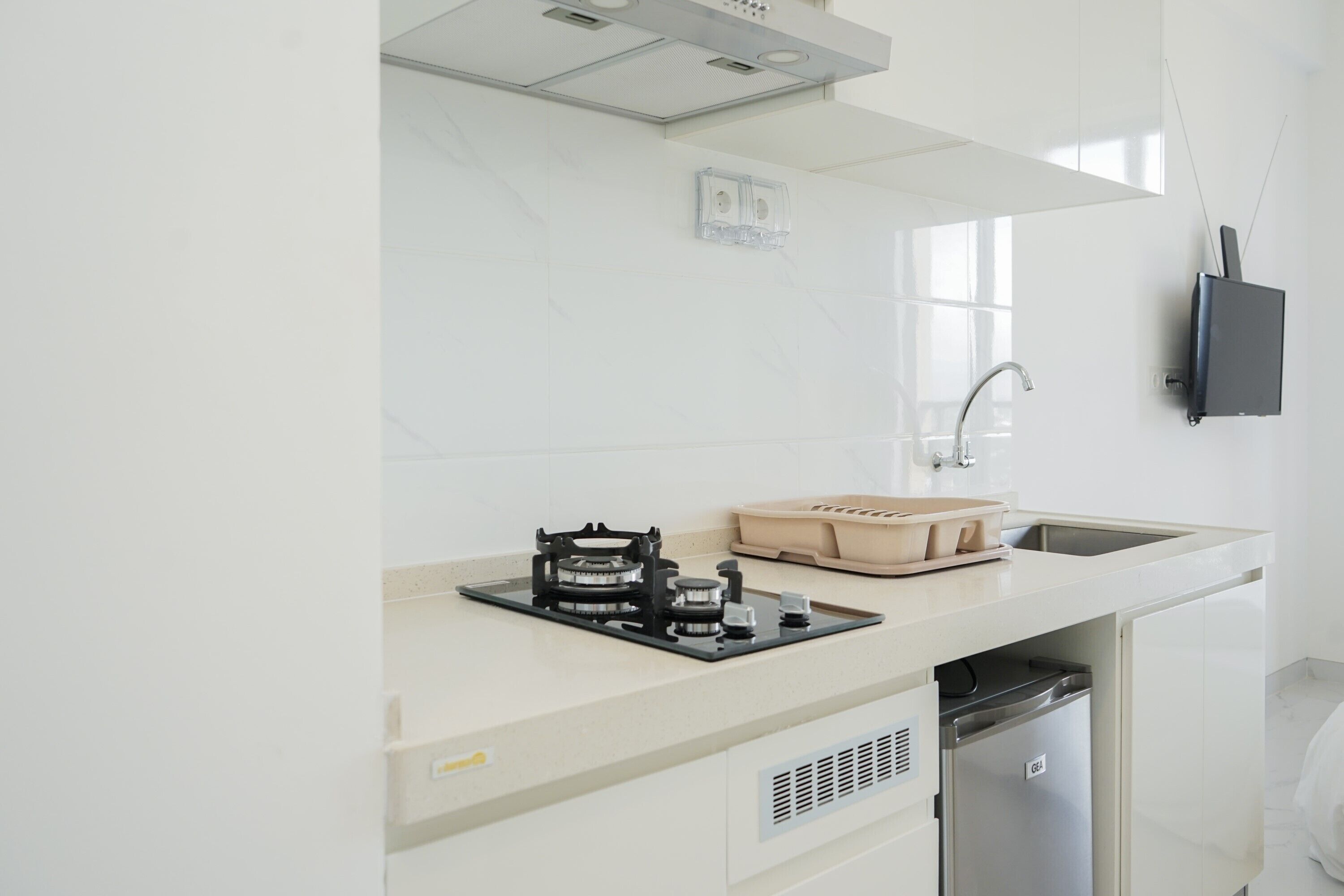 A modern kitchen with a built-in gas stove, a sink, and a dishwasher.