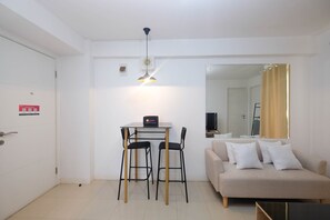 Cozy living space with a dining area, sofa, and television.