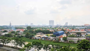 A residential area with houses and a river. - Nice and Elegant Studio at Riverview Jababeka Apartment (Cikarang)