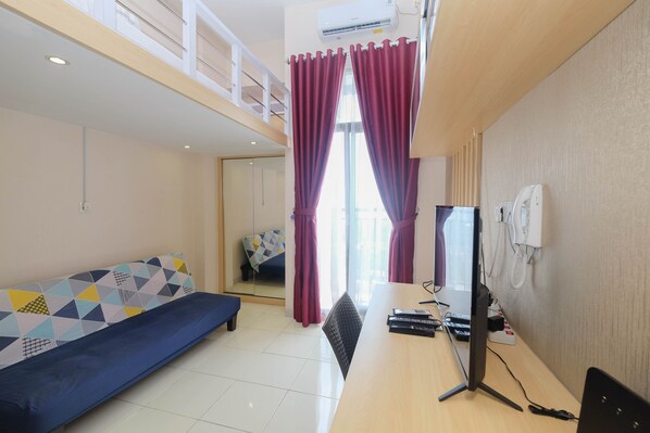 Room | Living area | TV - Comfy and Tidy Studio at Dave Apartment (Depok)