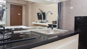 A modern bathroom with a double sink, a mirror, a toilet, and a shower. - Fancy and Nice Studio at Cinere Resort Apartment (Depok)
