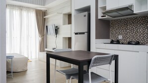 A modern kitchen with white cabinets, a black countertop, and a built-in stove.