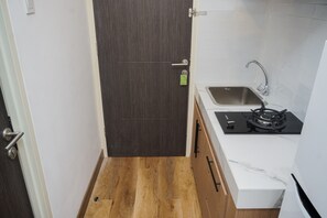 Fridge, stovetop, cookware/dishes/utensils - Comfortable and Simply Look Studio at Serpong Garden Apartment (Cisauk)