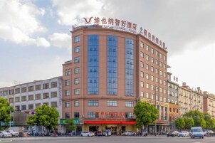 A multi-story hotel with a prominent sign at the top.